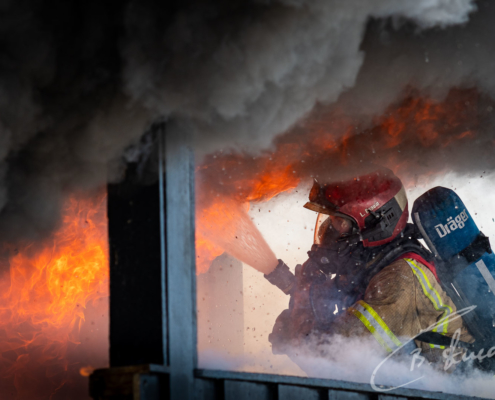 Firefighter controls flame