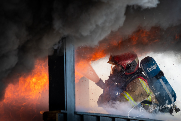 Firefighter controls flame